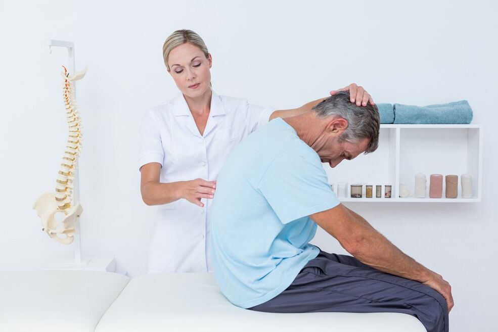 medicul examinează spatele cu osteocondroză